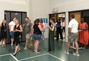 Parents entering the gym for a presentation on parent night.