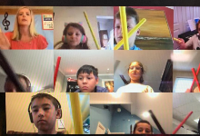 Mrs. Luehr, our music teacher, is using rhythm sticks to catch the beat during our music classes online through Google Meets. Students are seen holding different colored rhythm sticks. Mrs. Luehr is in the upper left hand corner of the screen instructing 
