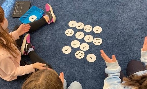 Students practicing their music notes by clapping