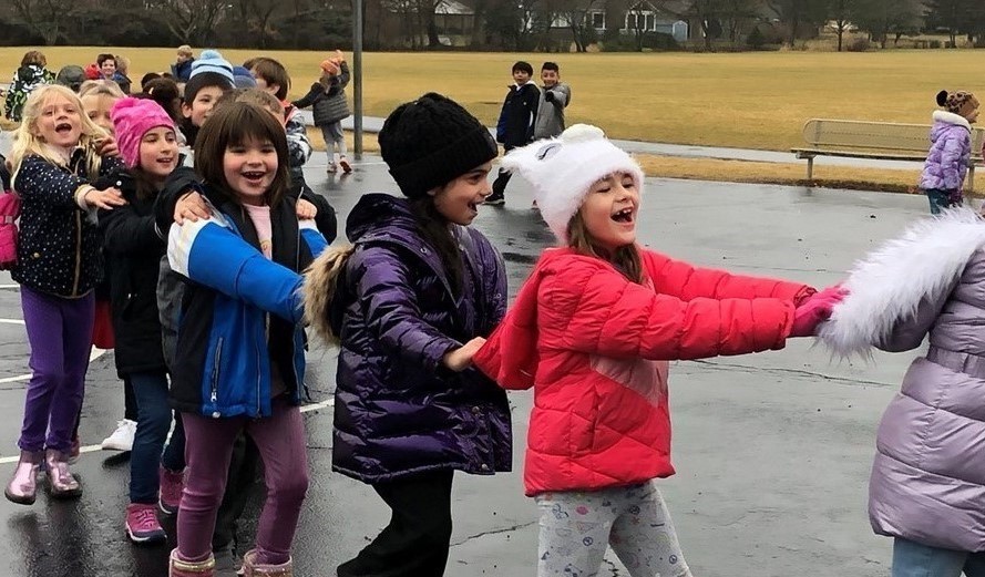 Students in a fun line on the playground.