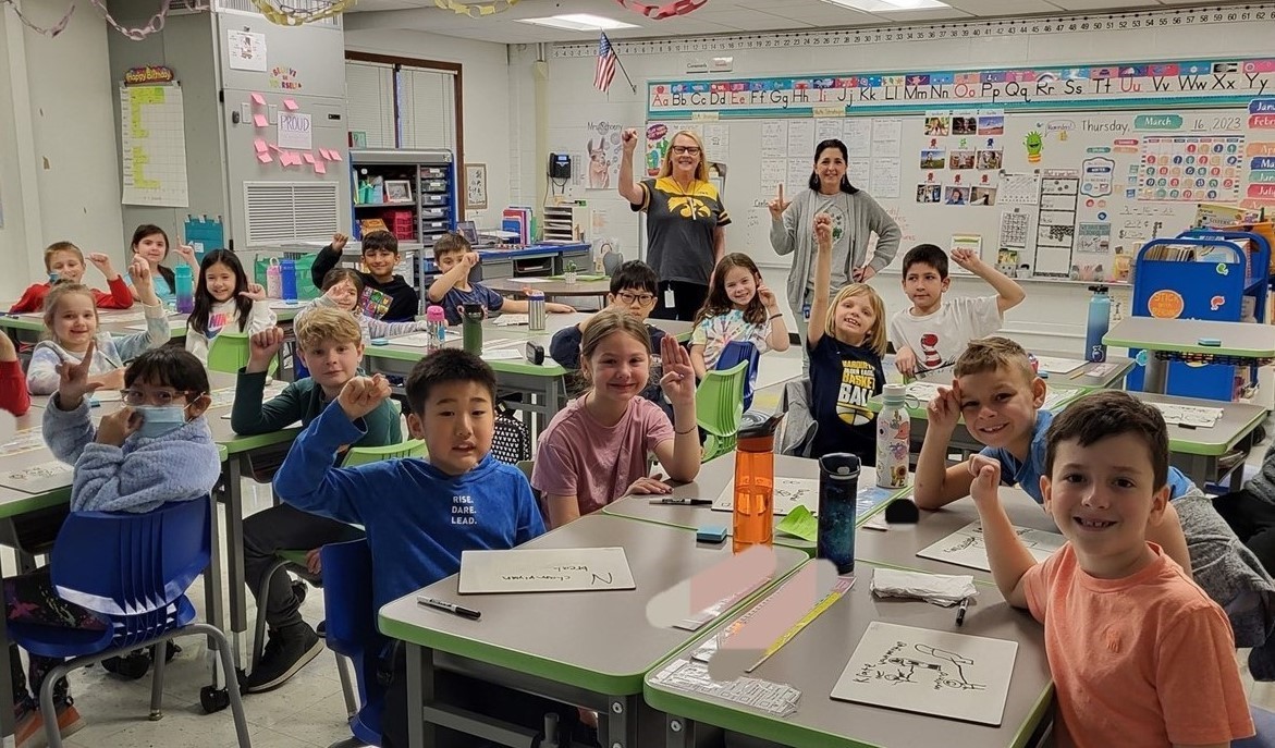 Students learning the ASL sign for their first initial of their name.